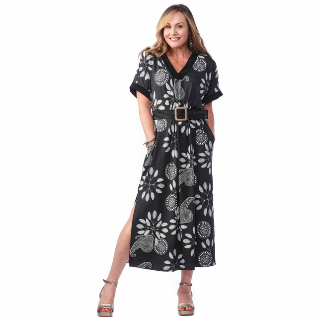 Model wearing the Pocketed Caftan Dress in black and white paisley