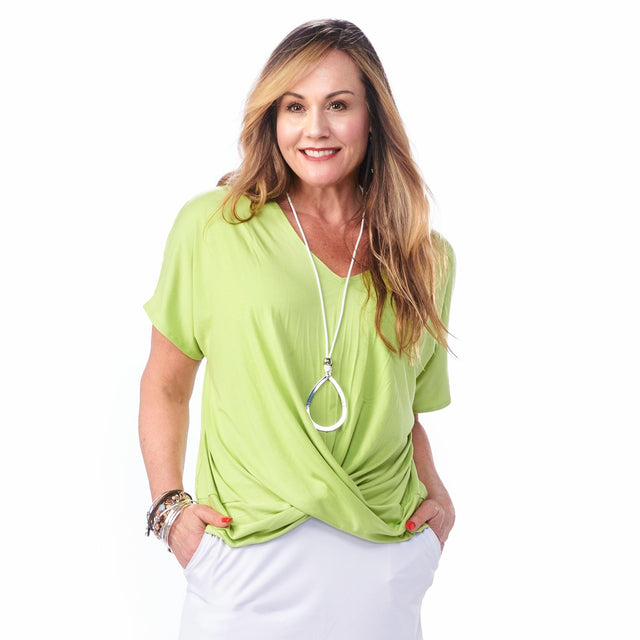 Model wearing the Bamboo Twist Top in lime green